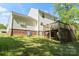 Wide shot of the backyard, showing the deck, air conditioning unit, and grass at 1694 Trotters Ridge Rd, Stanfield, NC 28163