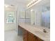 Well-lit bathroom featuring a long vanity and a large mirror at 1694 Trotters Ridge Rd, Stanfield, NC 28163