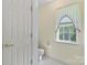 Small powder room with neutral walls and tile floor at 1694 Trotters Ridge Rd, Stanfield, NC 28163