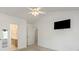 Bright bedroom featuring neutral carpeting, ceiling fan, and views to bathroom at 1694 Trotters Ridge Rd, Stanfield, NC 28163