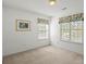 Bedroom features two windows, neutral walls, and plush carpeting at 1694 Trotters Ridge Rd, Stanfield, NC 28163