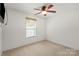 Bright bedroom with ceiling fan, large window, and plush carpeting at 1694 Trotters Ridge Rd, Stanfield, NC 28163