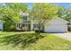 Charming two-story home with a well-manicured lawn, attached garage, and welcoming front porch at 1694 Trotters Ridge Rd, Stanfield, NC 28163