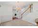 Bright foyer features a chandelier, stairs with wooden handrail, and decorative wall trim at 1694 Trotters Ridge Rd, Stanfield, NC 28163