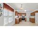 Kitchen features wooden cabinets, tiled floor, window, and white appliances at 1694 Trotters Ridge Rd, Stanfield, NC 28163