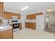 Open kitchen with wooden cabinets, white countertops, and tiled floor at 1694 Trotters Ridge Rd, Stanfield, NC 28163