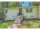 Attractive home exterior featuring brick steps, a dark-colored front door, and a decorative wreath at 1702 Herrin Ave, Charlotte, NC 28205