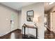 Inviting entryway with dark wood floors, a stylish console table, mirror, and a bright front door at 1702 Herrin Ave, Charlotte, NC 28205