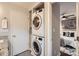 Convenient laundry area with stacked washer and dryer units adjacent to the main bedroom at 1702 Herrin Ave, Charlotte, NC 28205