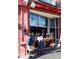 Patrons enjoying a meal at a Latin street grill with open-air seating and a lively atmosphere at 1702 Herrin Ave, Charlotte, NC 28205