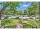 Residential street view featuring a well-maintained lawn, mature trees, and neighborhood homes at 1702 Herrin Ave, Charlotte, NC 28205
