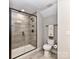 Bathroom featuring a tiled shower, modern toilet, neutral walls, and updated fixtures at 1805 Axholme Ct, Waxhaw, NC 28173