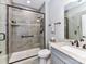 Updated bathroom featuring a glass shower with gray tile, granite counters, and a modern design at 1805 Axholme Ct, Waxhaw, NC 28173