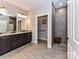 Bathroom featuring granite countertops, double sinks, tiled shower and floors, and abundant storage at 1805 Axholme Ct, Waxhaw, NC 28173