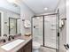 This bathroom features a glass shower, framed mirror, dark hardware, and a ceramic toilet for comfort and convenience at 1805 Axholme Ct, Waxhaw, NC 28173