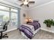 Bright bedroom with a ceiling fan, natural light from the window, and charming interior design at 1805 Axholme Ct, Waxhaw, NC 28173