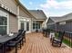 This deck features an outdoor kitchen and lots of seating space with views of the backyard at 1805 Axholme Ct, Waxhaw, NC 28173