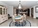 An open-concept dining room showcasing a decorative chandelier and light wood flooring at 1805 Axholme Ct, Waxhaw, NC 28173