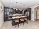 Gourmet kitchen showcasing dark wood cabinets, a central island, and modern lighting at 1805 Axholme Ct, Waxhaw, NC 28173