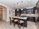 Elegant kitchen with dark cabinets, stainless steel appliances, and a large center island at 1805 Axholme Ct, Waxhaw, NC 28173