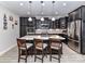 Stylish kitchen featuring dark wood cabinetry, stainless steel appliances, and marble countertops at 1805 Axholme Ct, Waxhaw, NC 28173