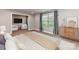 This main bedroom features neutral walls, a window, and a sitting room with a TV for additional living space at 1805 Axholme Ct, Waxhaw, NC 28173