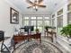 Bright home office with large windows, ceiling fan and built in shelving at 1805 Axholme Ct, Waxhaw, NC 28173