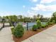 Well-maintained tennis court surrounded by lush greenery and a secure fence, ready for recreational play at 1805 Axholme Ct, Waxhaw, NC 28173