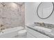 This bathroom features a bathtub with marble tile surround, a white toilet, and granite counters at 208 Spinners Dr, Cherryville, NC 28021