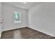 Bedroom with wood floors, light walls, a ceiling light, and a large window offering green outdoor views at 208 Spinners Dr, Cherryville, NC 28021