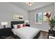 This bedroom is virtually staged with a bed, side tables, lamps, art, and a plant at 208 Spinners Dr, Cherryville, NC 28021