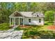 Inviting home with a covered porch, surrounded by a green lawn at 208 Spinners Dr, Cherryville, NC 28021