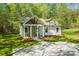 Charming home featuring a welcoming front porch with white columns and a spacious front yard at 208 Spinners Dr, Cherryville, NC 28021