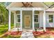 Close-up of a home's front porch, featuring a decorative door and pillars at 208 Spinners Dr, Cherryville, NC 28021