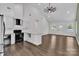 Open kitchen and living area with vaulted ceilings, stainless steel appliances, and granite countertops at 208 Spinners Dr, Cherryville, NC 28021