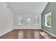 Bright living room with wood floors, white walls, and natural light from multiple windows at 208 Spinners Dr, Cherryville, NC 28021