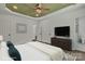 This bedroom features multiple doors, white walls, and a view to the spacious bathroom at 208 Spinners Dr, Cherryville, NC 28021