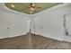 Spacious main bedroom features neutral walls, wood floors, ceiling fan, and attached bathroom with marble tile at 208 Spinners Dr, Cherryville, NC 28021