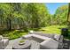 This beautiful patio is surrounded by mature trees, lush grass, and nature at 208 Spinners Dr, Cherryville, NC 28021