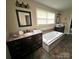 Primary bathroom with a soaking tub, double vanity, and natural light at 2116 Dana Pl, Shelby, NC 28152