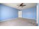 Neutral bedroom featuring a ceiling fan, neutral carpet, and two doorways at 2120 Turtle Point Rd, Charlotte, NC 28262