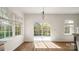 Sunlit dining area featuring a sliding glass door to the deck and views of the backyard at 2120 Turtle Point Rd, Charlotte, NC 28262