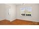 Bright dining room featuring hardwood floors, a large window, and a modern secure front door at 2120 Turtle Point Rd, Charlotte, NC 28262