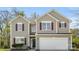 Charming two-story home featuring a two-car garage, neutral siding, and attractive red shutters at 2120 Turtle Point Rd, Charlotte, NC 28262