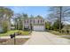 A spacious driveway leading to a two-story home featuring neutral siding and vibrant red shutters at 2120 Turtle Point Rd, Charlotte, NC 28262