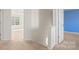 A hallway with carpeted floors leading to a bedroom with a window and a door to a room with blue walls at 2120 Turtle Point Rd, Charlotte, NC 28262
