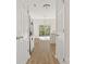 Bright kitchen showcasing hardwood floors, white cabinets, stainless refrigerator and natural light at 2120 Turtle Point Rd, Charlotte, NC 28262