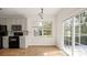 Kitchen and dining area with black appliances and sliding glass door with view to the backyard at 2120 Turtle Point Rd, Charlotte, NC 28262