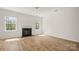Bright, open living room featuring hardwood floors and a cozy fireplace at 2120 Turtle Point Rd, Charlotte, NC 28262
