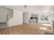 Open-concept living space with hardwood floors, staircase, and views into the kitchen at 2120 Turtle Point Rd, Charlotte, NC 28262